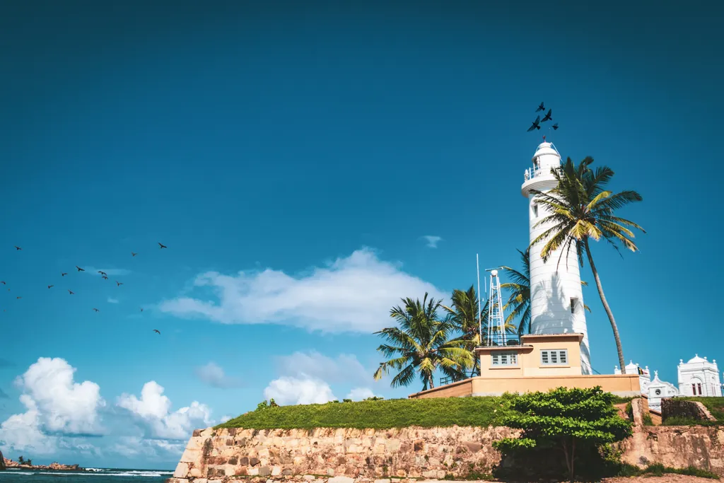 The white lighthouse inside Galle Fort, seen over the rampart wall