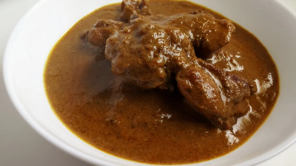 A Sri Lankan chicken curry, deep red with roasted spice