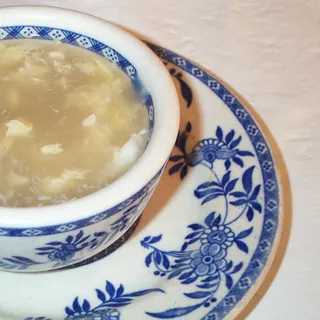 Egg drop soup with ribbons of egg through a clear broth