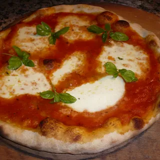 A margherita pizza with mozzarella and basil