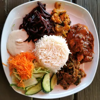 A Sri Lankan rice and curry plate, with rice, curries, sambol and salad